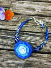 Corsage bracelet, stunning handmade  polymer clay roses with crystals and gems.
