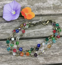 Harlequin: Stunning, hand wired triple stranded Swarovski crystal bracelet in 4 colour choices of metal